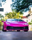 Vertical shot of a one of one Lamborghini Huracan with a carbon fiber body kit in a pink color