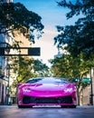 Vertical shot of a one of one Lamborghini Huracan with a carbon fiber body kit in a pink color