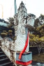 Vertical shot of One of the many amazing statues in Bali on the fence of a public staircase