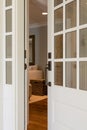 Vertical shot of an open, wooden front door