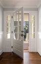 Vertical shot of an open, wooden front door