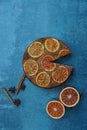 Vertical shot of orange cake with cinnamon and blood orange pieces on blue background Royalty Free Stock Photo