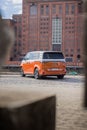 Vertical shot of an orange Volkswagen VW ID Buzz Pro modern Electric car outdoors in Denmark