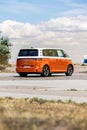 Vertical shot of an orange Volkswagen VW ID Buzz Pro modern Electric car outdoors in Sweden