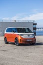 Vertical shot of an orange Volkswagen VW ID Buzz Pro modern Electric car outdoors in Sweden