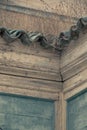 Vertical shot of the ornamented top of an old wooden Moroccan building