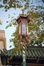 Vertical shot of an ornate lantern street lamp along the streets of Chinatown in San Francisco