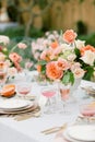 Vertical shot of an outdoor wedding table with flowers and elegant tableware Royalty Free Stock Photo