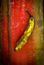 Vertical shot of an over riped banana on a wooden surface