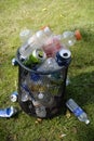 Vertical shot of overflowing trash full of aluminum cans, plastic bottles in Missouri