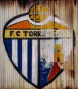 Vertical shot of a painted Football club logo FC Torrevieja on a rusty gate