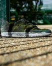 Vertical shot of a pair of dirty man sneakers outdoors