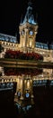 Vertical shot of the palace of culture in Iasi reflected on the water at night, Romania Royalty Free Stock Photo