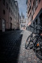 Vertical shot of a parked bicycle in the alley in Cologne