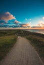 Vertical shot of a paved pathway by the sea under the cloudy sky captured in Domburg, Netherlands Royalty Free Stock Photo