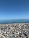 Vertical shot of a pebbled beach against a blue sea in Batumi, Georgia on a clear summer day