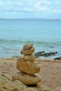 Vertical shot of pebbles on the beach balanced perfectly on top of each other Royalty Free Stock Photo