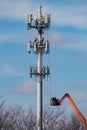 Vertical shot of people on a crane near the Antenna tower Royalty Free Stock Photo