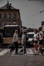 Vertical shot of people crossing the road with vehicles stopped in the background, Namur, Belgium