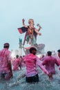 Vertical shot of people in front of Ganesha on the Ganpati Visarjan, Girgaon Chowpatty, India