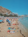 Vertical shot of people relaxing on the beach in Spain