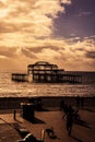 Vertical shot of people resting in the Brighton West Pier during sunset Royalty Free Stock Photo