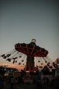 Vertical shot of people riding a carousel in an amusement park during the night Royalty Free Stock Photo