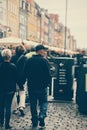 Vertical shot of people walking around in the streets of Copenhagen, Denmark