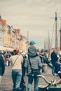 Vertical shot of people walking around in the streets of Copenhagen, Denmark