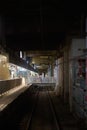 Vertical shot of people walking in the old Hung Hom station in  Hong Kong at night Royalty Free Stock Photo