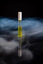 Vertical shot of perfume sample bottle with steam.