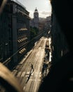 Vertical shot of a person crossing the street in Lisbon captured from the window of a building