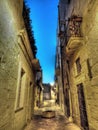 Vertical shot of a person sitting at the streetcorner in Lecce, Italy