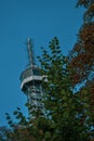 Vertical shot of Petrin Lookout Tower covered by a tree on Petrin hill in Prague, Czech Republic Royalty Free Stock Photo