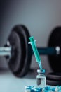 Vertical shot of pharmaceutical syringe with needle in a medicine and pills - illegal doping drugs Royalty Free Stock Photo