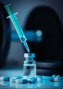 Vertical shot of pharmaceutical syringe with needle in a medicine and pills - illegal doping drugs Royalty Free Stock Photo