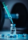 Vertical shot of pharmaceutical syringe with needle in a medicine and pills - illegal doping drugs