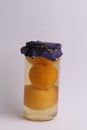 Vertical shot of pickled peaches in a jar isolated on a white background Royalty Free Stock Photo