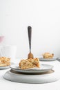 Vertical shot of a piece of crispy pie in a plate on the table