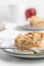 Vertical shot of a piece of crispy pie in a plate on the table