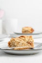 Vertical shot of a piece of crispy pie in a plate on the table