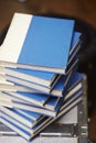 Vertical shot of a pile of blue books on blurred background Royalty Free Stock Photo