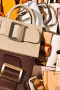 Vertical shot of a pile of fashion leather handbags