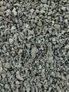 Vertical shot of a pile of gray pebbles of varying sizes on the ground