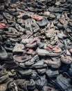 Vertical shot of a pile of old shoes on a dumpsite in Poland Royalty Free Stock Photo