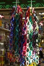 Vertical shot of piles of colorful bracelets hanging from hooks in the shop