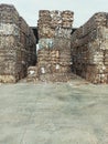 Vertical shot of piles of pressed waste paper bales in the yard, waste paper recycling concept