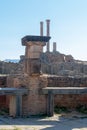 Vertical shot of the pillars and walls of the famous Roman ruins in Timgad, Algeria