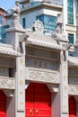 Vertical shot of the Pilu Temple in China standing against a background of a modern building