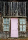 Vertical shot of a pink door of an old wooden house in a ghost town in Colorado, USA Royalty Free Stock Photo
